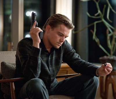 Inception - Leonardo DiCaprio sitting with gun